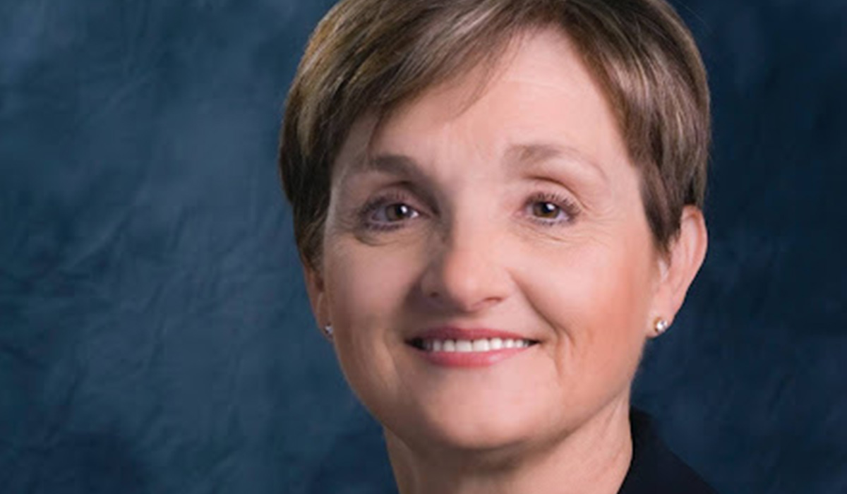 Jena Dickey headshot on a blue background